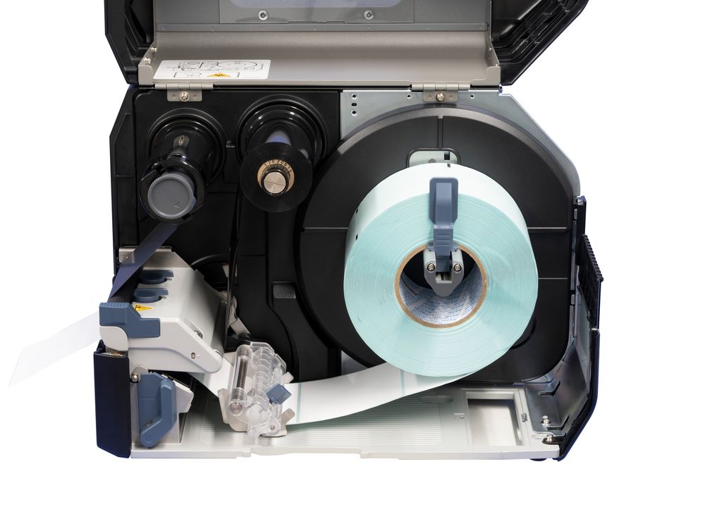 Sato CL4NX Plus label printer open with label roll inserted