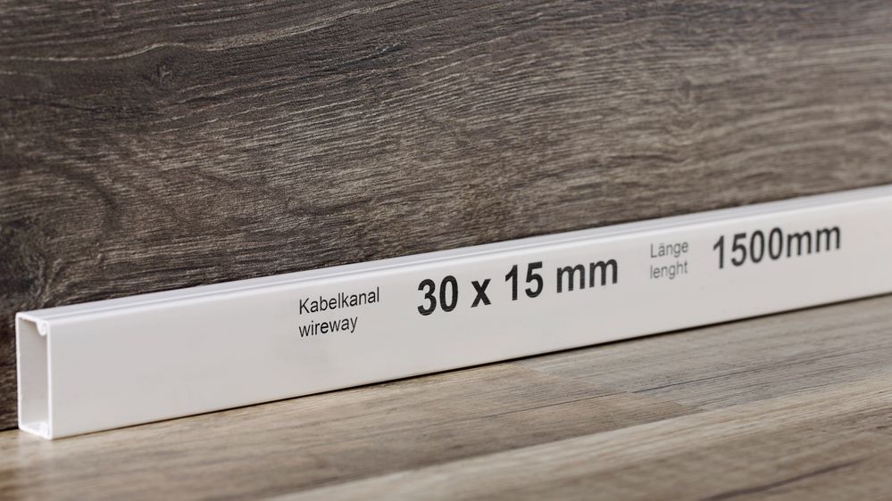 Black inkjet labeling on a white cable canal